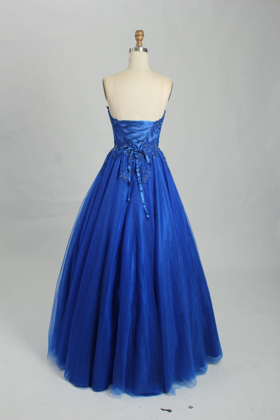 Back view of Leah Royal Blue Corset Ballgown with lace-up corset closure and voluminous tulle skirt. Perfect for formal occasions or prom night.