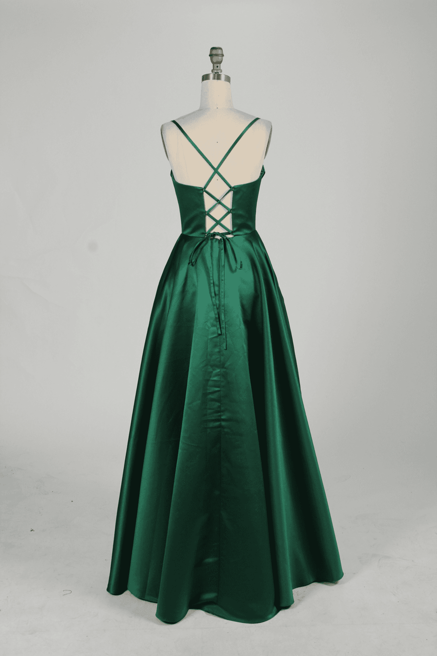 Back view of Keira emerald green satin ballgown featuring lace-up corset detail and flowing A-line skirt, ideal for formal events.