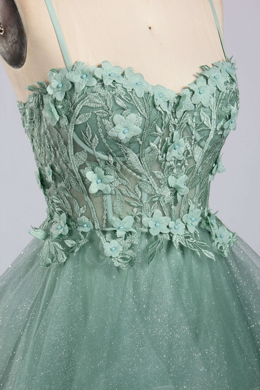 Close-up of Jessica Stuart Sage Gown bodice with intricate 3D floral appliqué and embroidered lace detail, perfect for prom or bridesmaid looks.