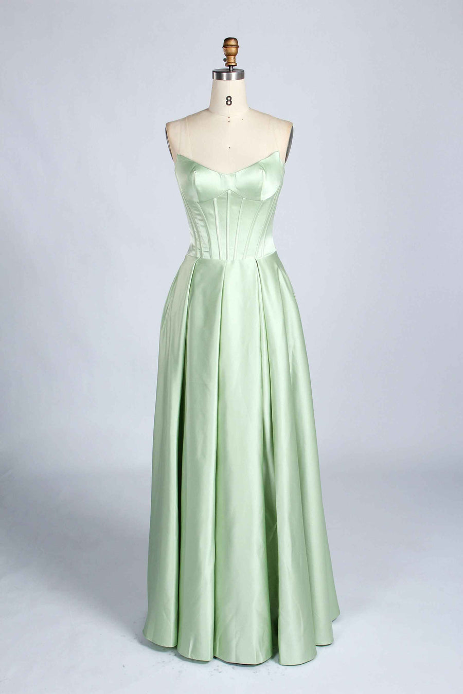 Front view of sage green Jessica Stuart Darcet Prom Gown with strapless boned bodice and pleated satin skirt.