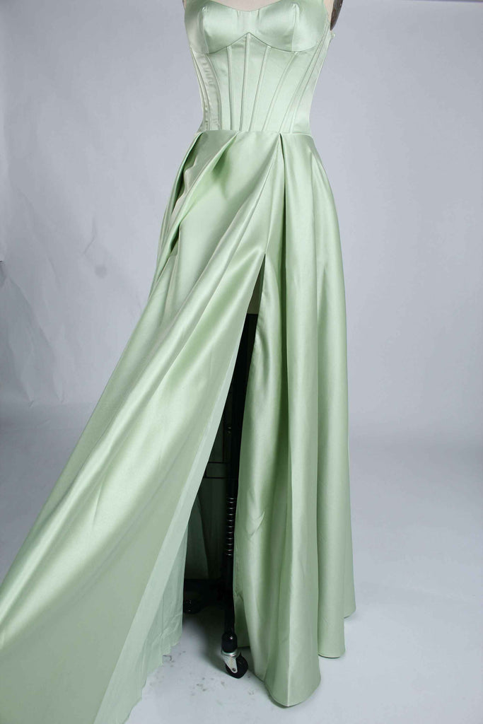 Side view of sage green Jessica Stuart Darcet Prom Gown highlighting thigh-high slit and elegant satin drape.