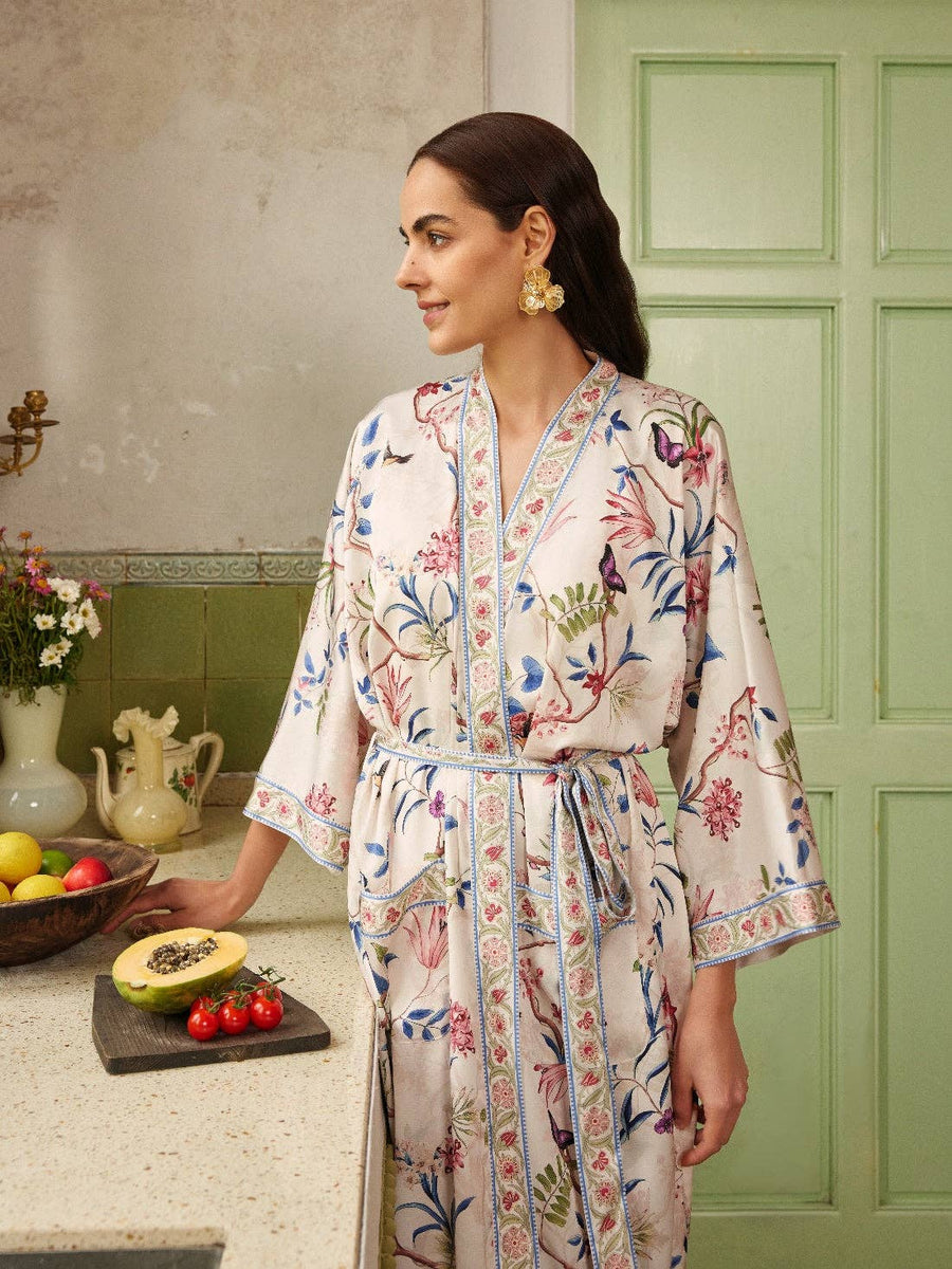 Beige Chinoiserie Kimono Robe with floral print, modeled in a rustic kitchen setting. Elegant bridal spa wrap fits sizes S to XL.
