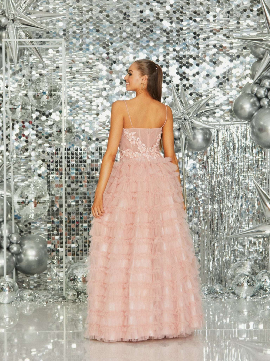 Back view of Alice Prom Dress by Tiffanys in blush pink with sheer floral bodice and layered tulle skirt. Formal ballgown at Cargo Clothing.