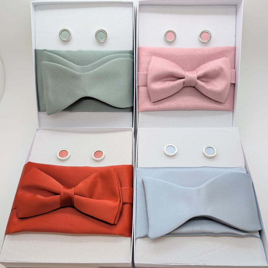 Wedding bow tie gift sets in sage green, blush pink, rust orange, and powder blue. Includes bow tie, pocket square, and cufflinks.