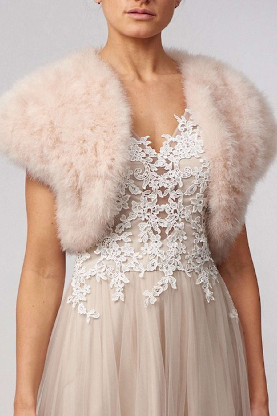 Blush pink Feather Shrug FK042 by Mascara London over a nude lace gown, a chic accessory for cocktail or bridal events.