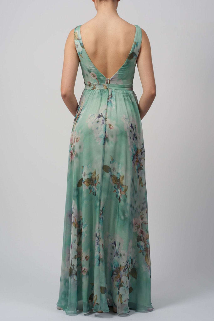 Back view of Chiffon Dress MC11314 showcasing low V-shaped back, floral chiffon fabric, and elegant floor-length flow.