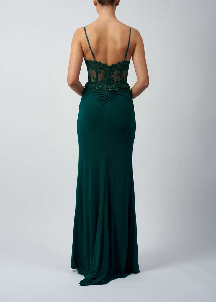 Back view of Mascara MC123210 fitted corset dress in green, featuring sheer lace corset, ruched waist, and flowing jersey skirt.