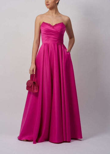 Mascara London MC124112 Navy Strapless Satin Ballgown in vibrant pink with sweetheart neckline, ruched bodice, and full-length skirt with pockets.