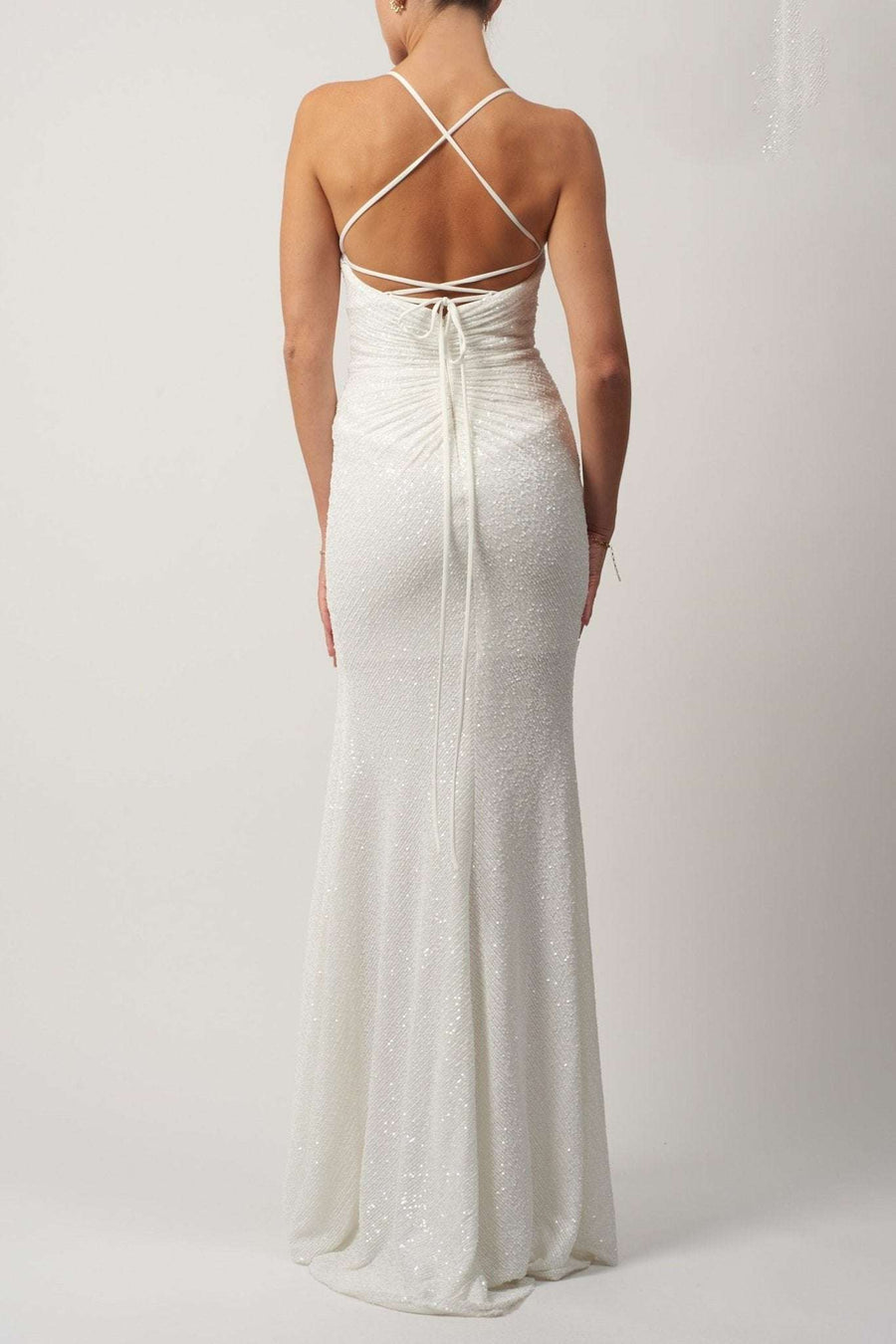 Sequin Long Dress - MC186119 shown from the back, featuring a low-back design with crisscross spaghetti straps and waist tie detail.