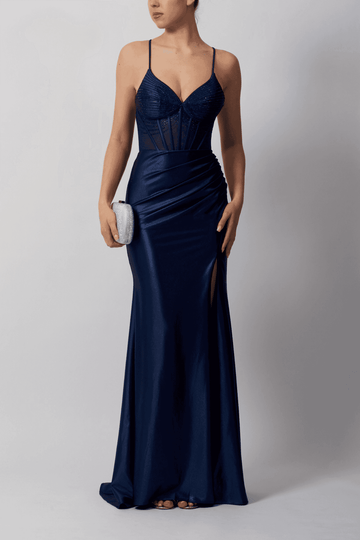Navy fitted evening gown with beaded corset bodice, ruched jersey skirt and side split, perfect for summer formal events