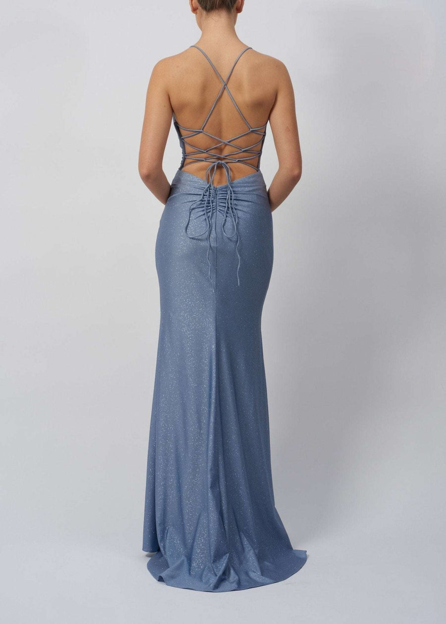 Back view of Mascara Airforce Rouched Tie Back Dress MC29335 showing crisscross tie back detail, ruched design, and shimmering fabric in light blue.