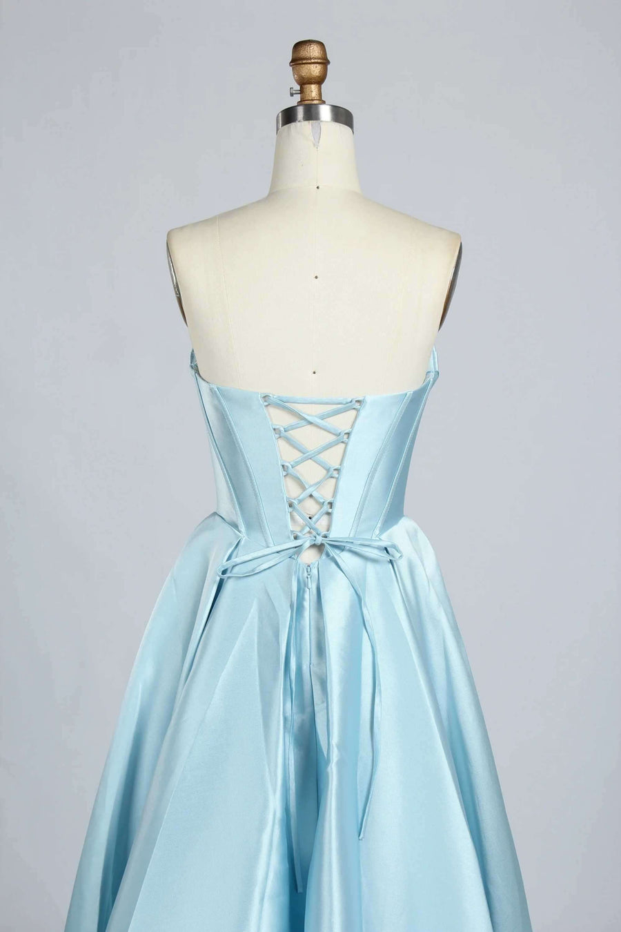 Detailed view of lace-up back design on the light blue satin Phoebe Prom Gown, showcasing adjustable fit and satin ribbon tie.