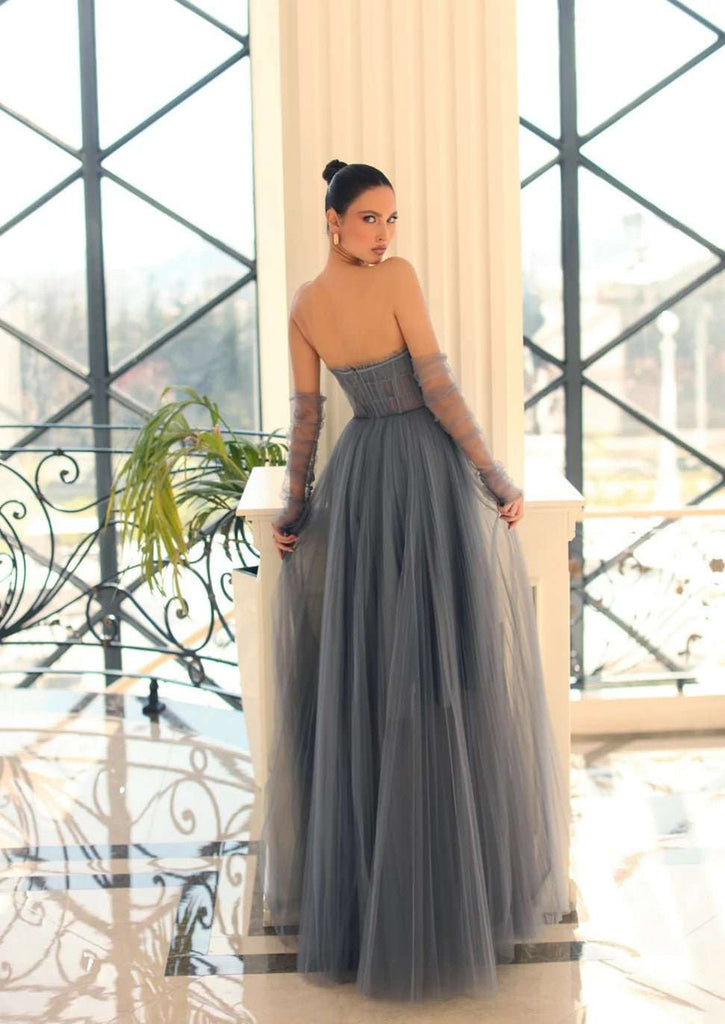 Nicoletta NC1064 Steel Grey Strapless Tulle Gown with sheer corset bodice and full A-line skirt, styled with matching mesh gloves.
