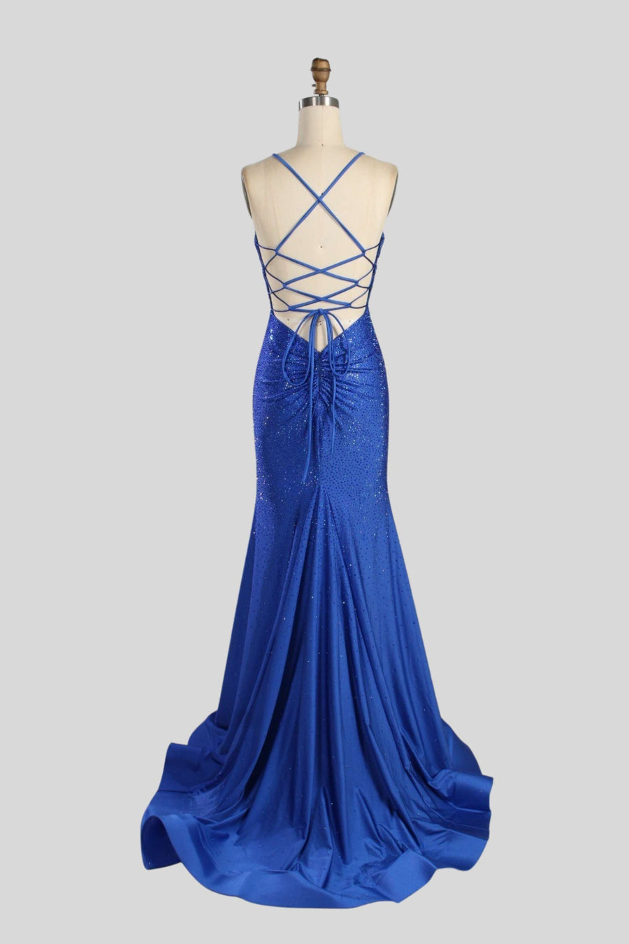 Poppy royal blue Rhinestone Prom Dress with lace-up back and fitted silhouette in shimmering satin. Backless design perfect for prom or red carpet events.