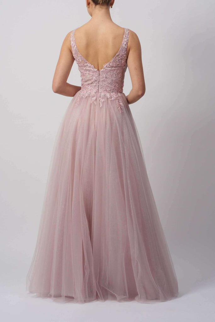Back view of pink V-neck tulle ballgown featuring floral lace and glitter details, ideal for formal occasions and prom nights.