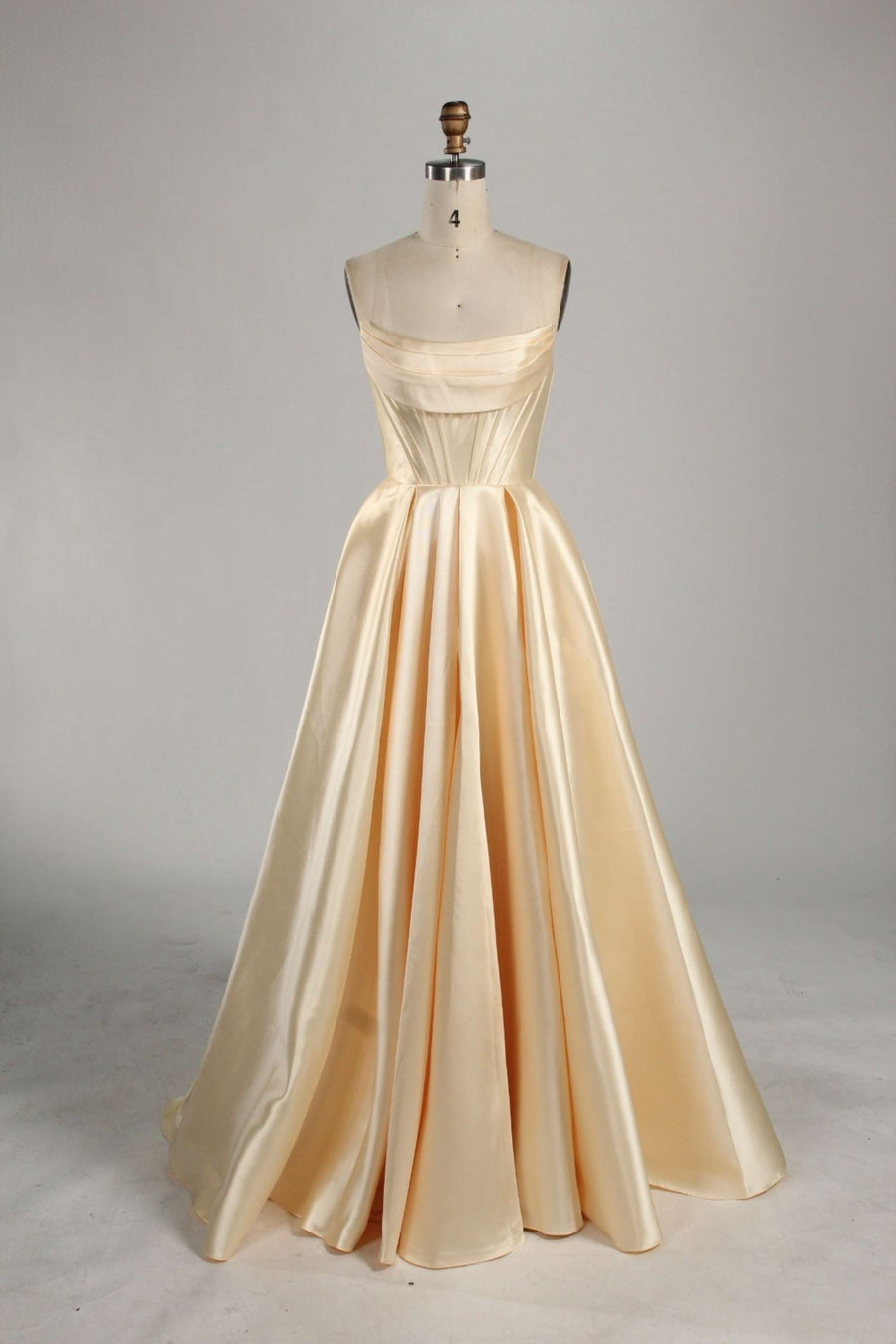 Jessica Stuart yellow satin ball gown with pockets, featuring a strapless bodice and full-length flowing skirt. Ideal for prom or elegant events.