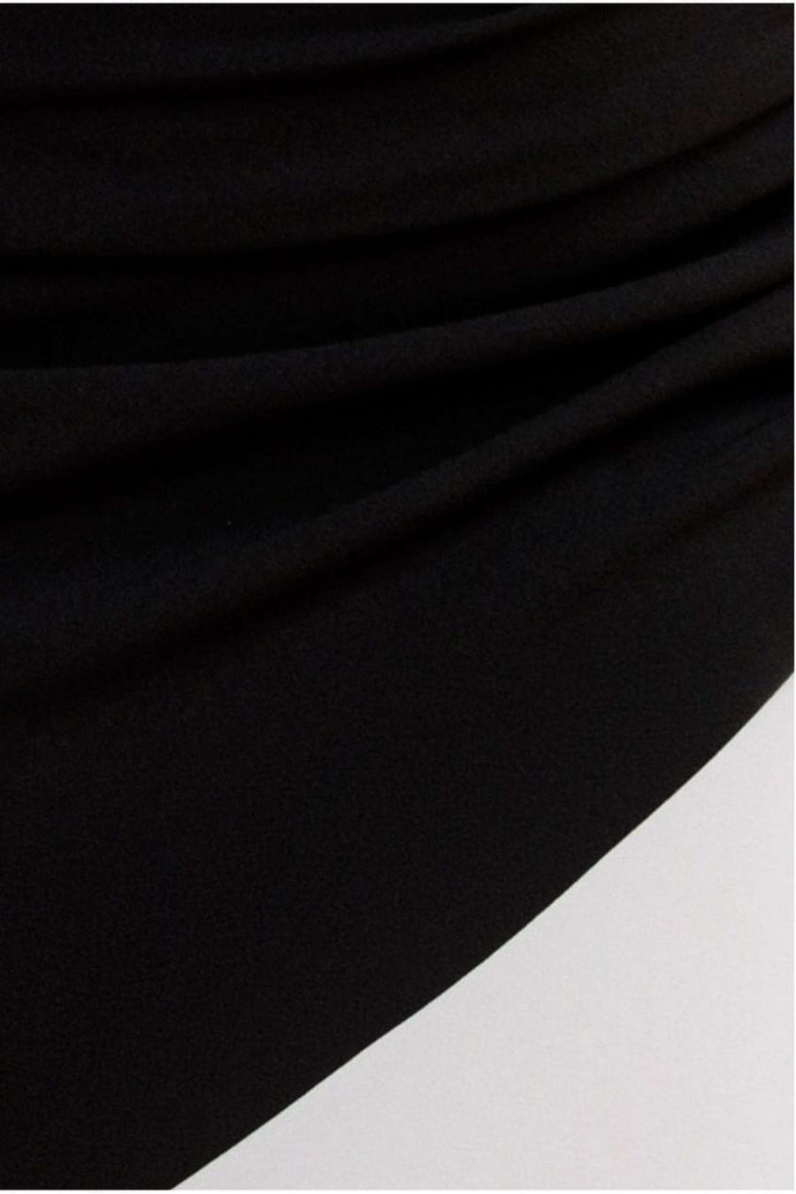 Close-up of Goddiva Maxi Dress in black cream, showcasing ruched detailing and smooth fabric texture on the mermaid hem silhouette.