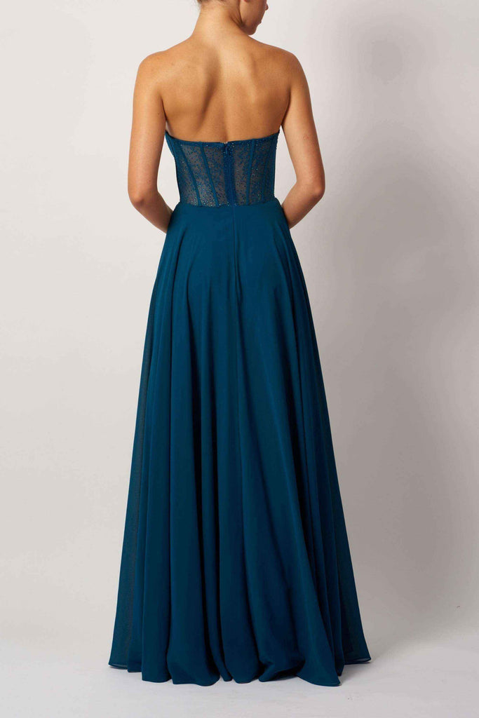 Back view of teal corset chiffon evening dress with strapless lace bodice and flowing floor-length skirt.