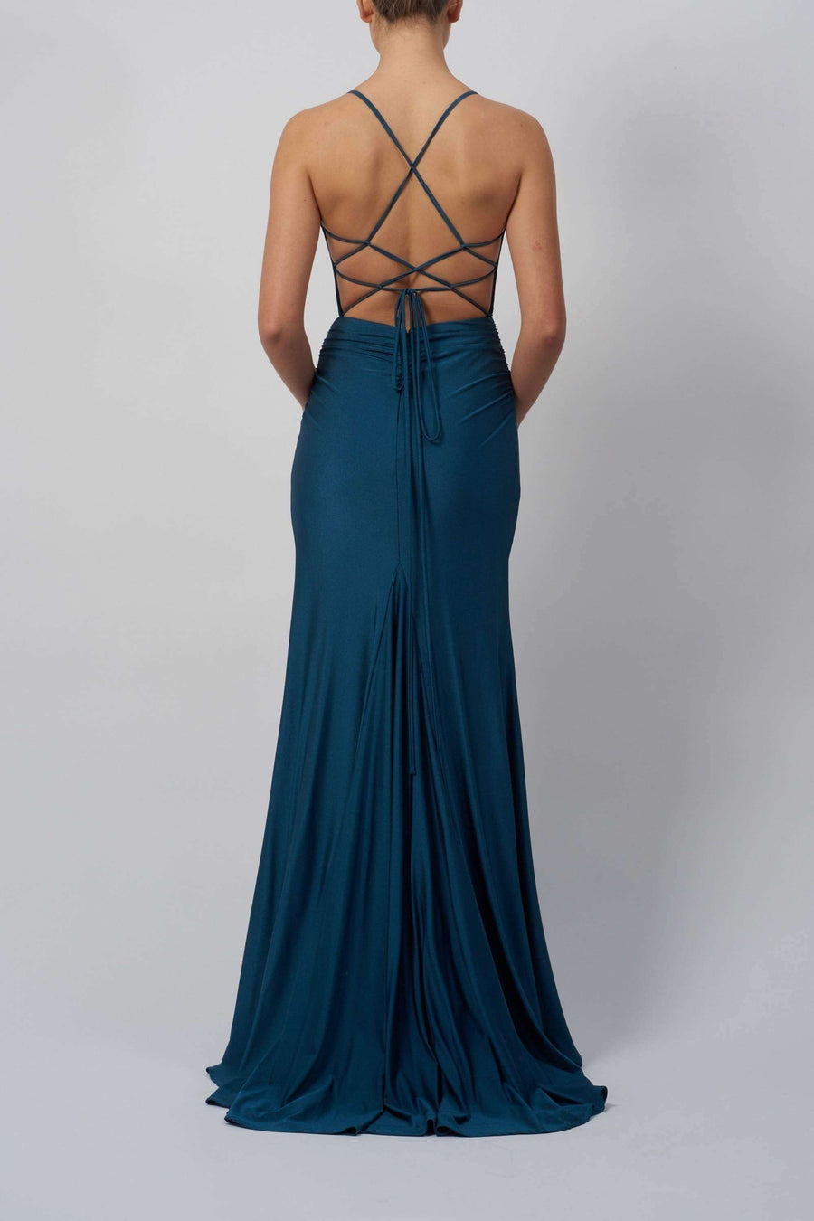 Back view of Mascara MC11332 teal jersey dress featuring elegant cross-back straps and flowing silhouette for a comfortable, stylish fit.