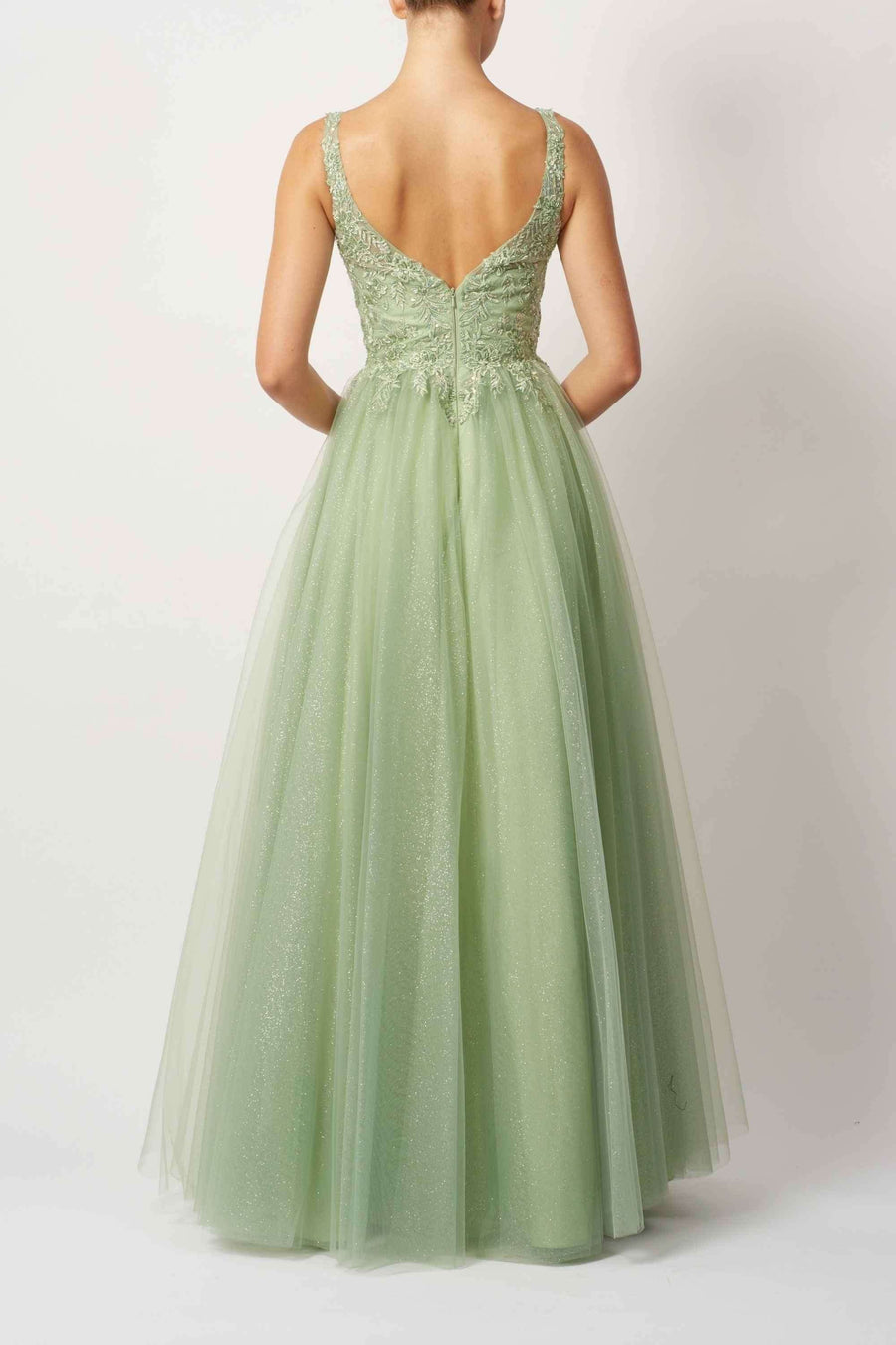 Back view of Pistachio EMB Tulle Gown MC11346 showcasing deep V-back and glitter tulle layers, perfect for bridesmaids or formal occasions.