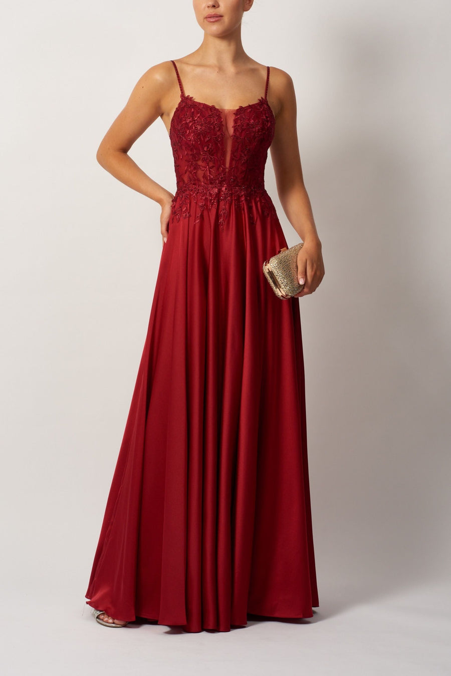 Wine corset dress with lace applique bodice and sparkly gem straps, ideal for bridesmaids or prom. Features flowing satin skirt and elegant fit.