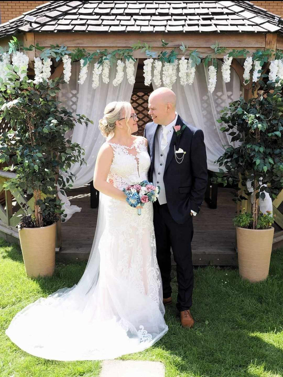 Groom wearing the Snowdrop Ivory Wedding Tie - Perfect Bridal Accessory, paired with a navy suit and ivory waistcoat for a classic wedding style.
