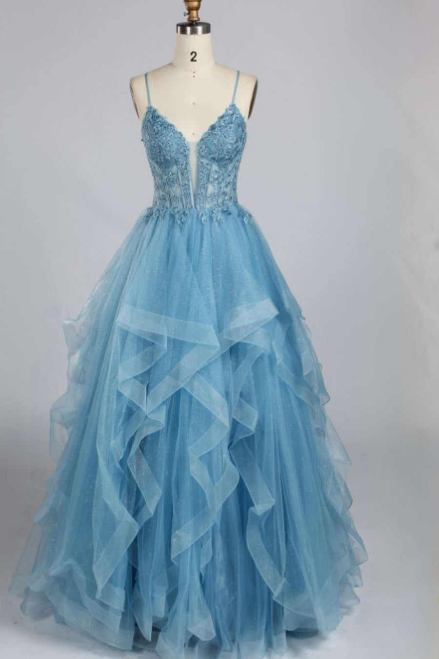 Jessica Stuart Dolly Ruffle Baby Blue Tulle Ball Gown with plunging neckline and layered skirt, perfect for prom or red carpet events.