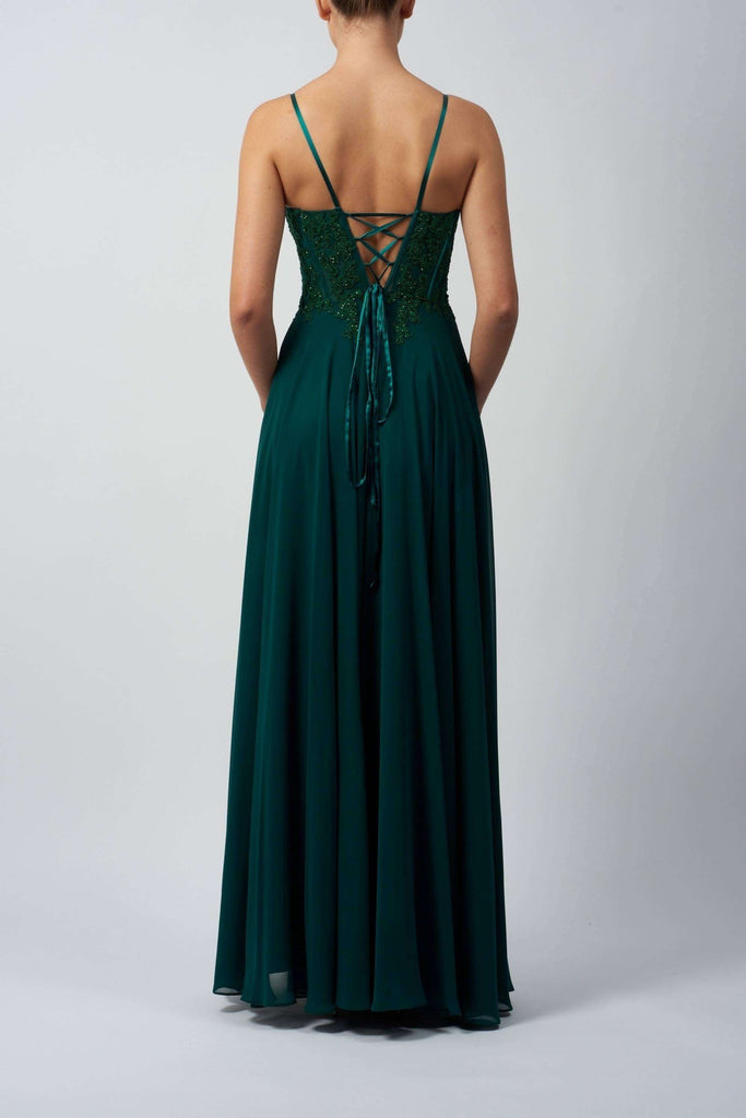 Mascara Chiffon Dew Gown in deep green with lace-up back detail, ideal for prom or bridesmaids. Features flowing chiffon skirt and fitted bodice.