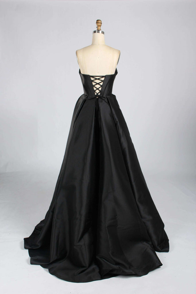 Back view of Jessica Stuart 33313B black satin strapless prom gown with lace-up corset closure and dramatic floor-length skirt.