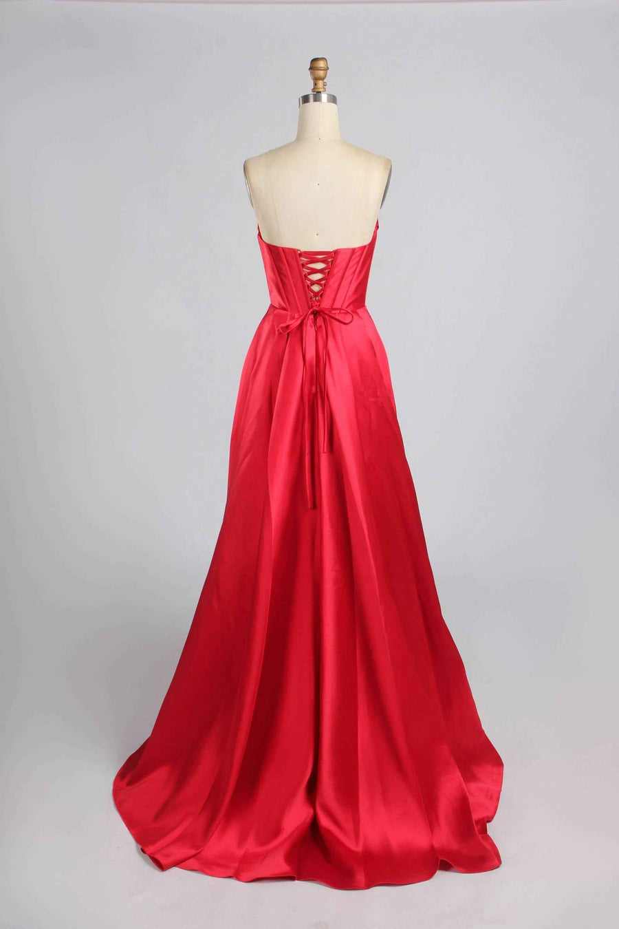 Back view of Jessica Stuart Red Pearl Evening Gown showcasing lace-up corset closure and elegant satin train for formal occasions.