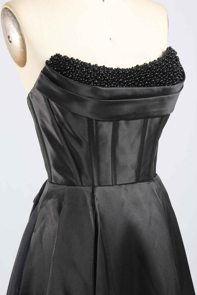 Close-up of Jessica Stuart Black Pearl Gown bodice featuring intricate black pearl embellishments and structured satin corset design.