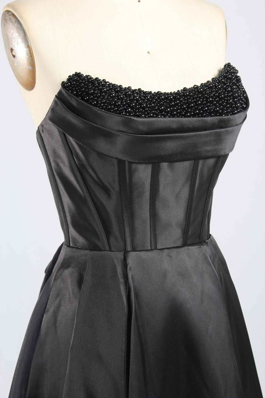 Close-up of Jessica Stuart Black Pearl Gown bodice featuring intricate black pearl embellishments and structured satin corset design.