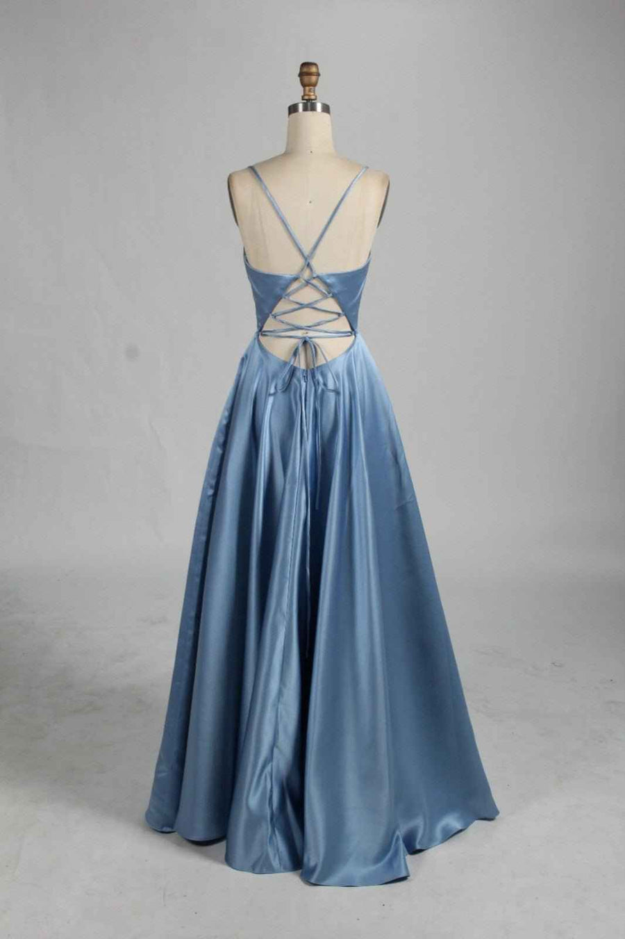 AVA Open Back Dusty Blue Prom Dress with full skirt and lace-up closure. Features a deep V-back and elegant satin finish, ideal for formal events.