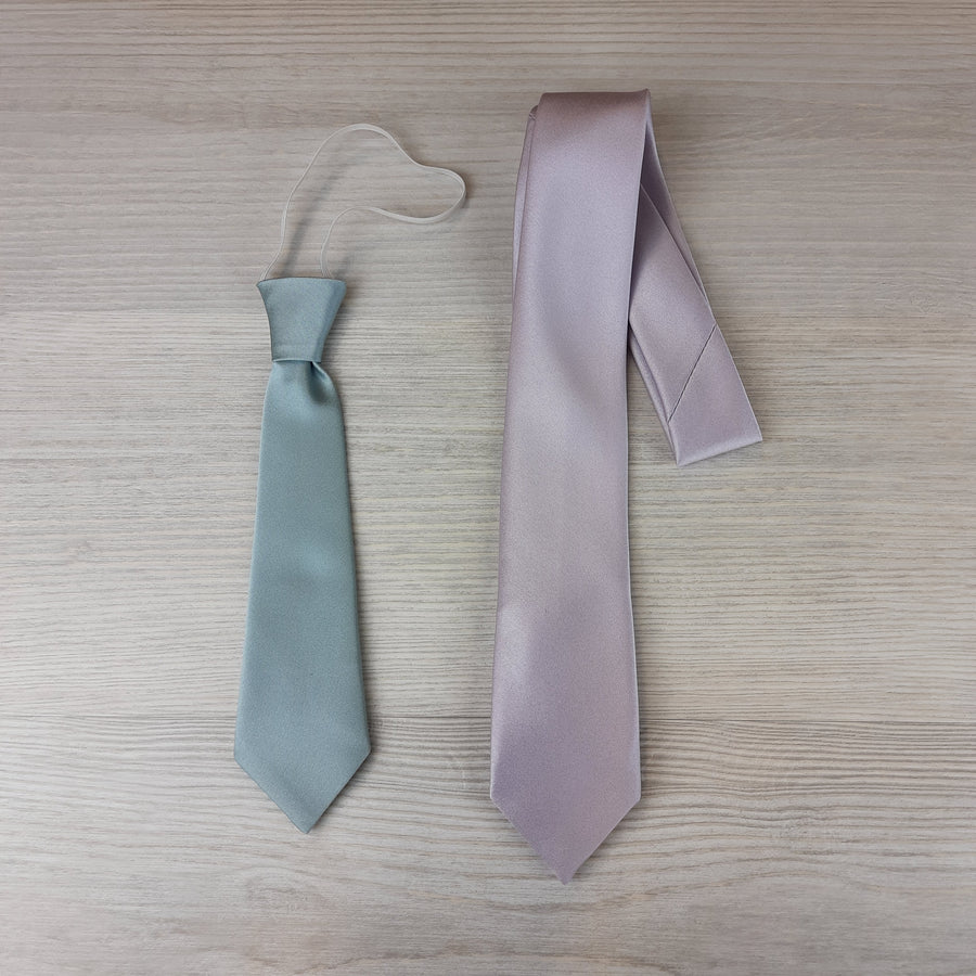 Peacock Boys Ties in two sizes: elasticated tie in light blue and self-tie in lilac, ideal for ages 5-12. Dry clean only.