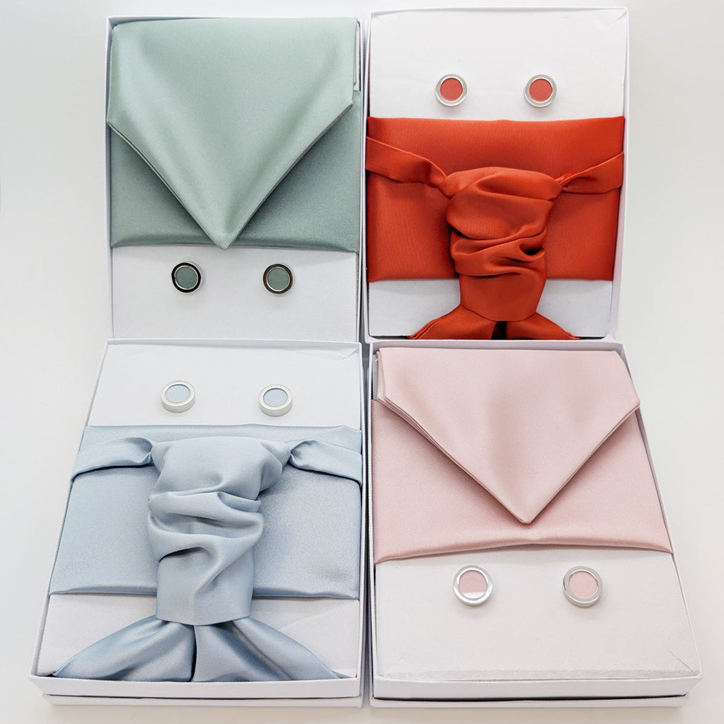 Assorted handmade wedding cravats in pastel and bold tones with matching cufflinks, perfect for groomsmen or formal wear accessories.