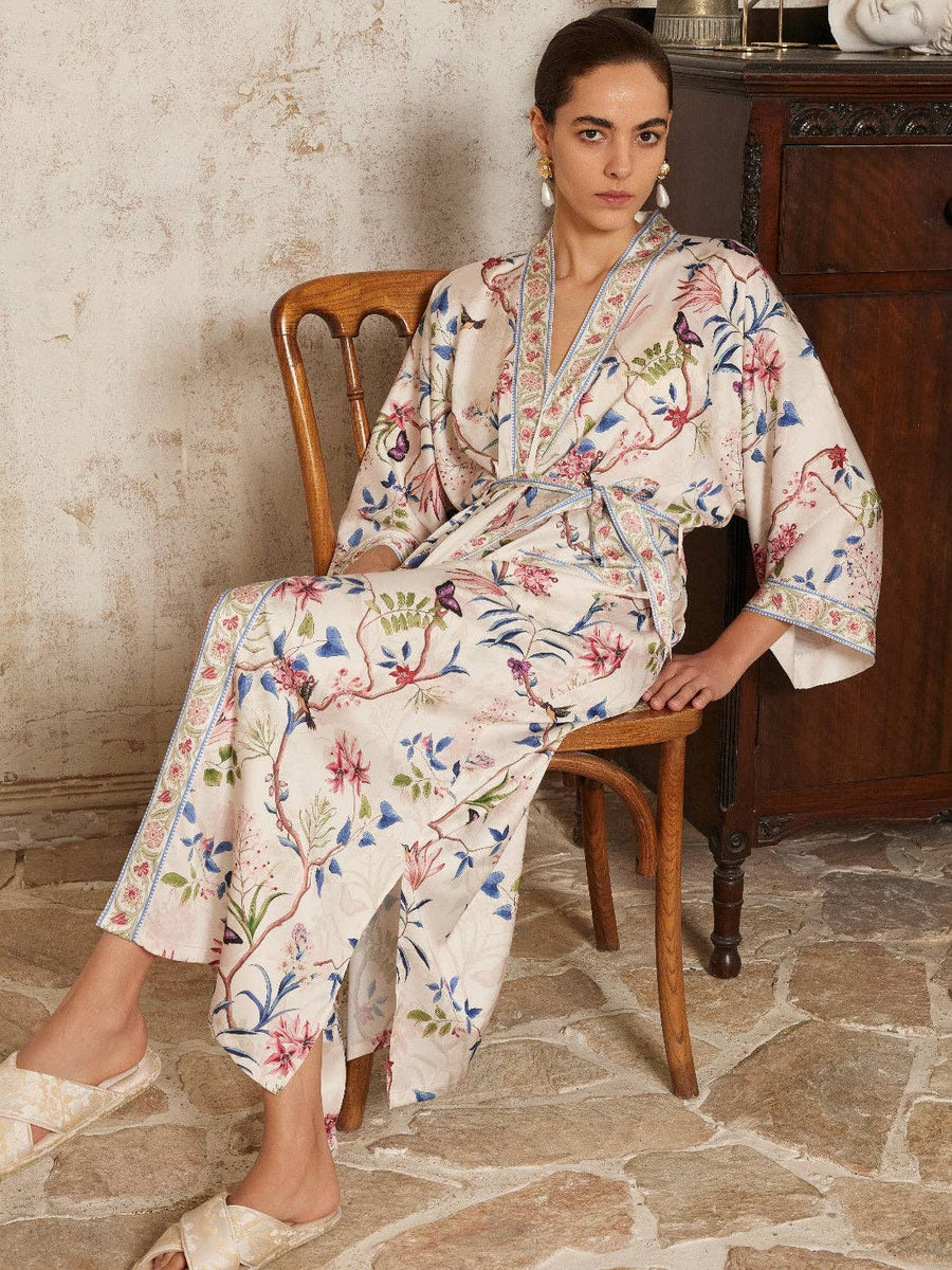 Model seated in Beige Chinoiserie Kimono Robe featuring vibrant floral motifs. Ideal for bridal spa moments, fits S to XL.