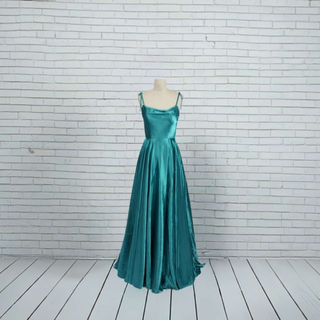 Abby Teal Ballgown in satin with tie-up straps and full-length skirt. Elegant teal dress with pockets, ideal for prom or bridesmaid wear.
