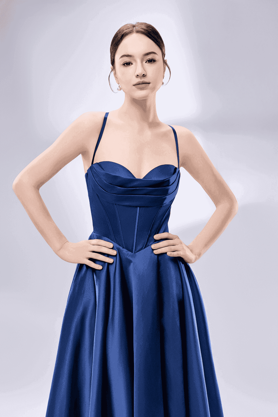 Front view of model in navy blue Keira satin ballgown showing sweetheart neckline and fitted corset bodice for prom or evening wear.