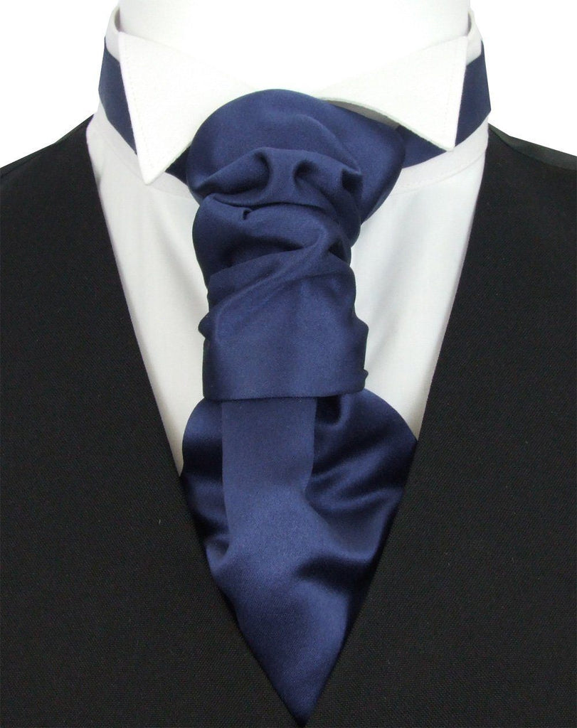 Boys Wedding Cravat in midnight blue satin with pre-tied knot, shown on white shirt and black vest. Ideal for ages 5-12, adjustable fit.