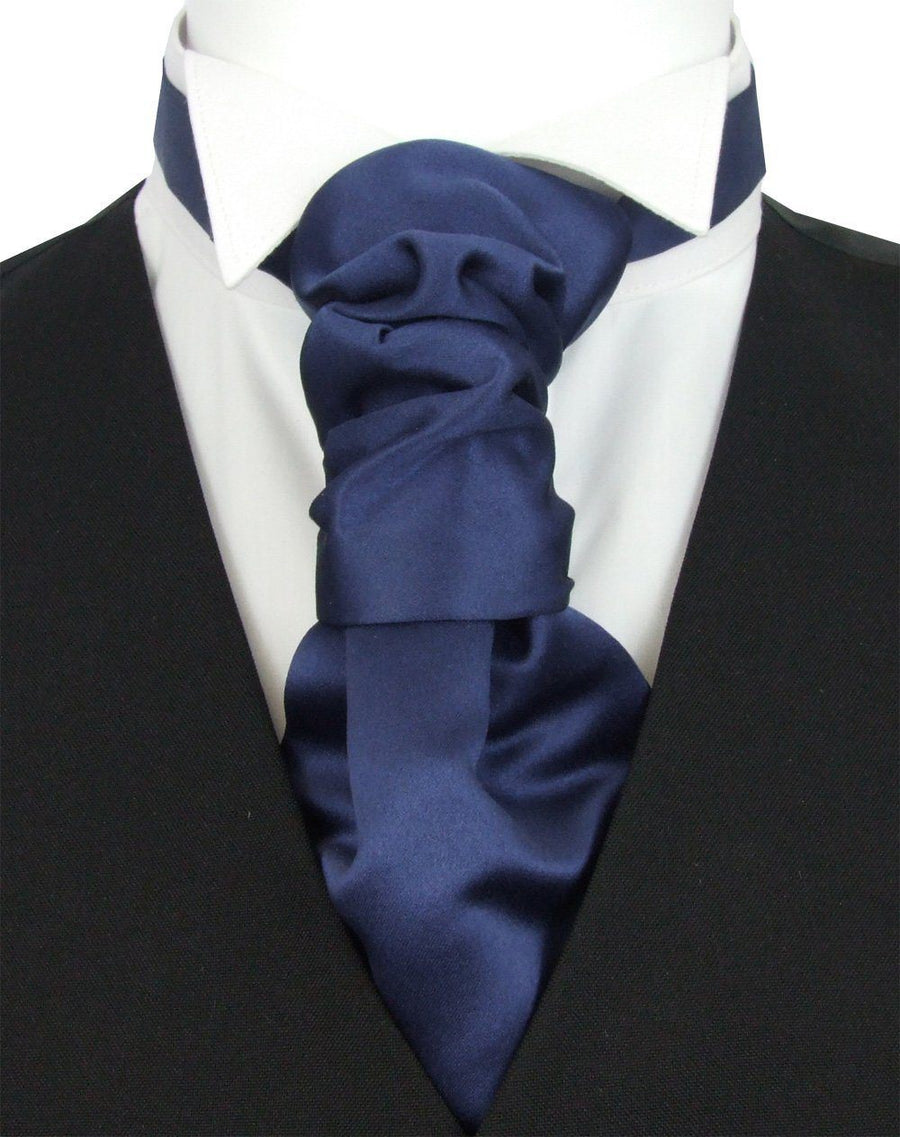Boys Wedding Cravat in midnight blue satin with pre-tied knot, shown on white shirt and black vest. Ideal for ages 5-12, adjustable fit.
