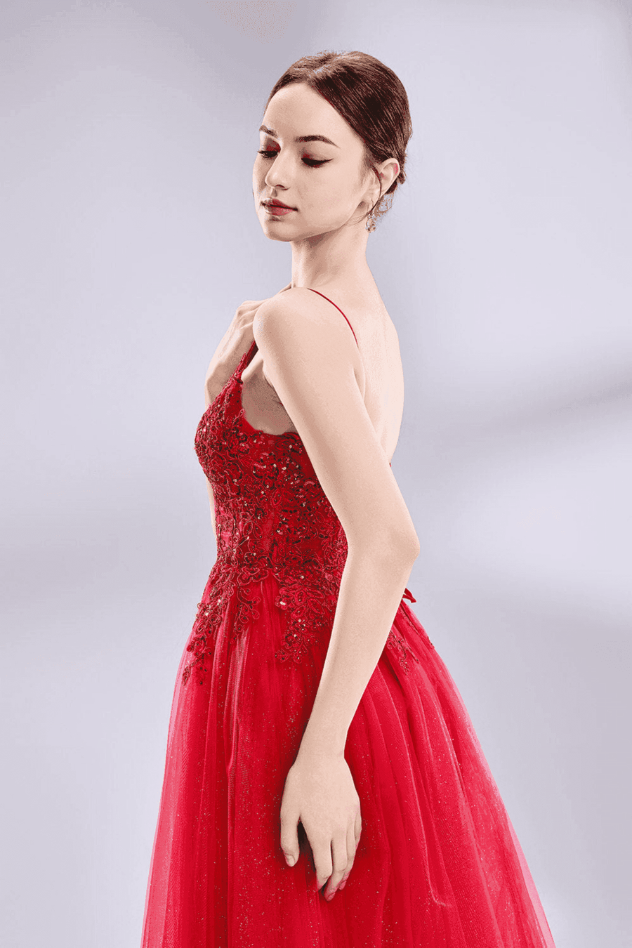 Jessica Stuart Nina Beaded Ball Gown with spaghetti straps and side slit, shown in a red variant with glitter tulle and embroidered bodice.