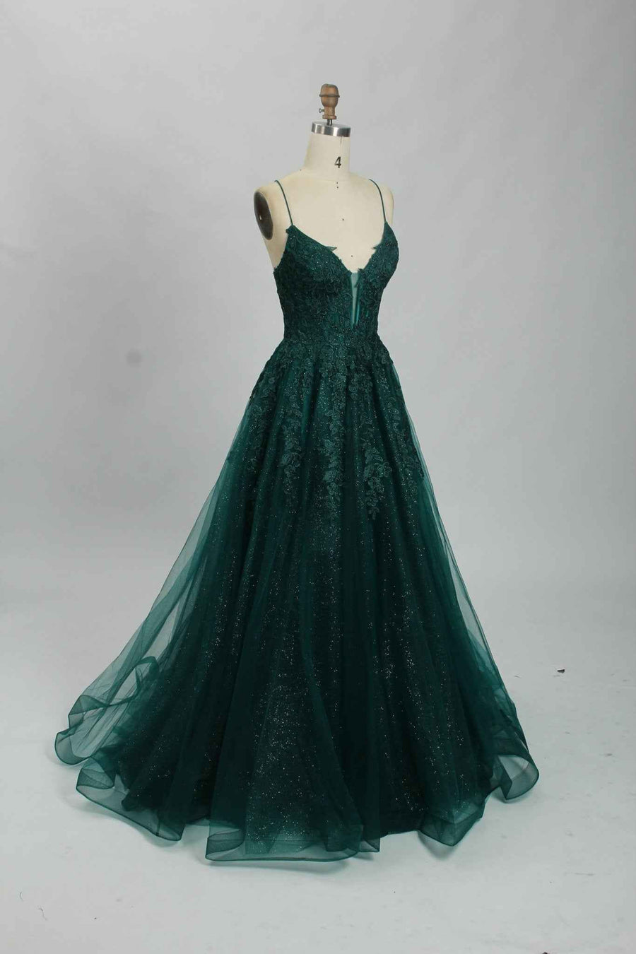 Joy Tulle Ballgown in deep green with floral applique and glitter tulle, ideal for prom or black-tie events. Features a fitted corset bodice and flowing skirt.