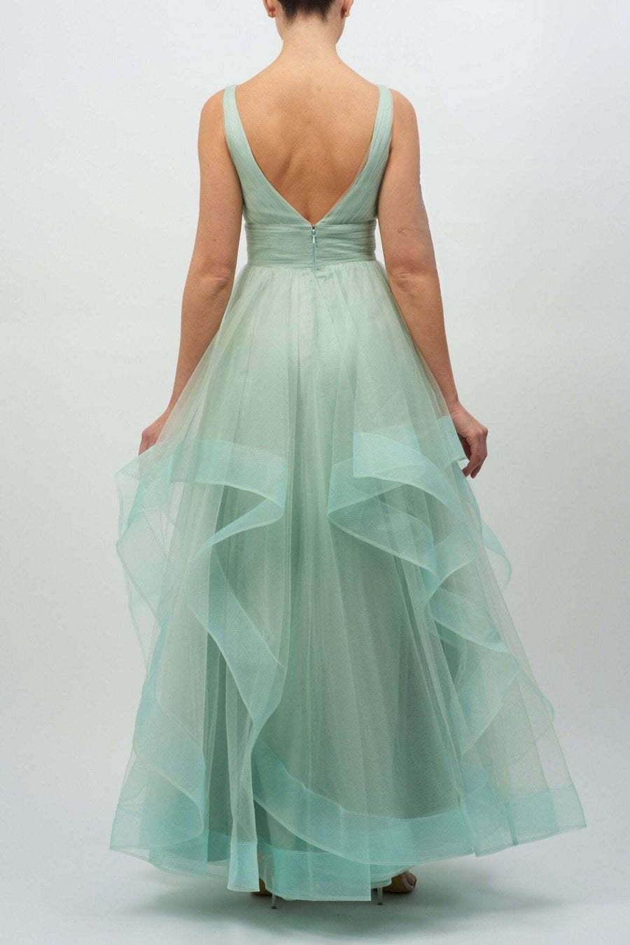 Back view of Mascara London MC11207 green tulle princess ballgown featuring a V-back, layered tulle skirt, and elegant zip closure.