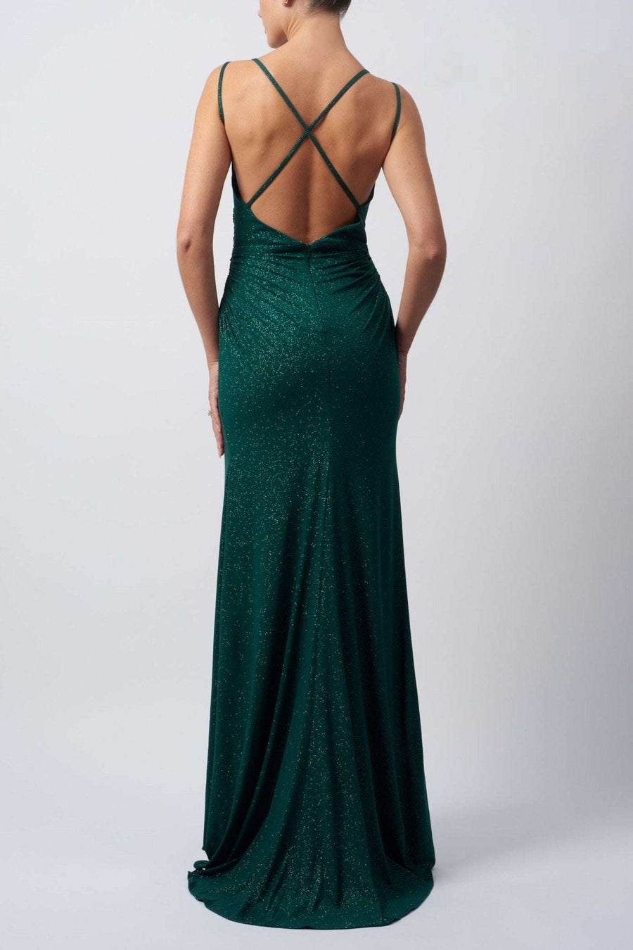 back view of lady wearing a forest green evening dress in stretch glitter fabric with rouching