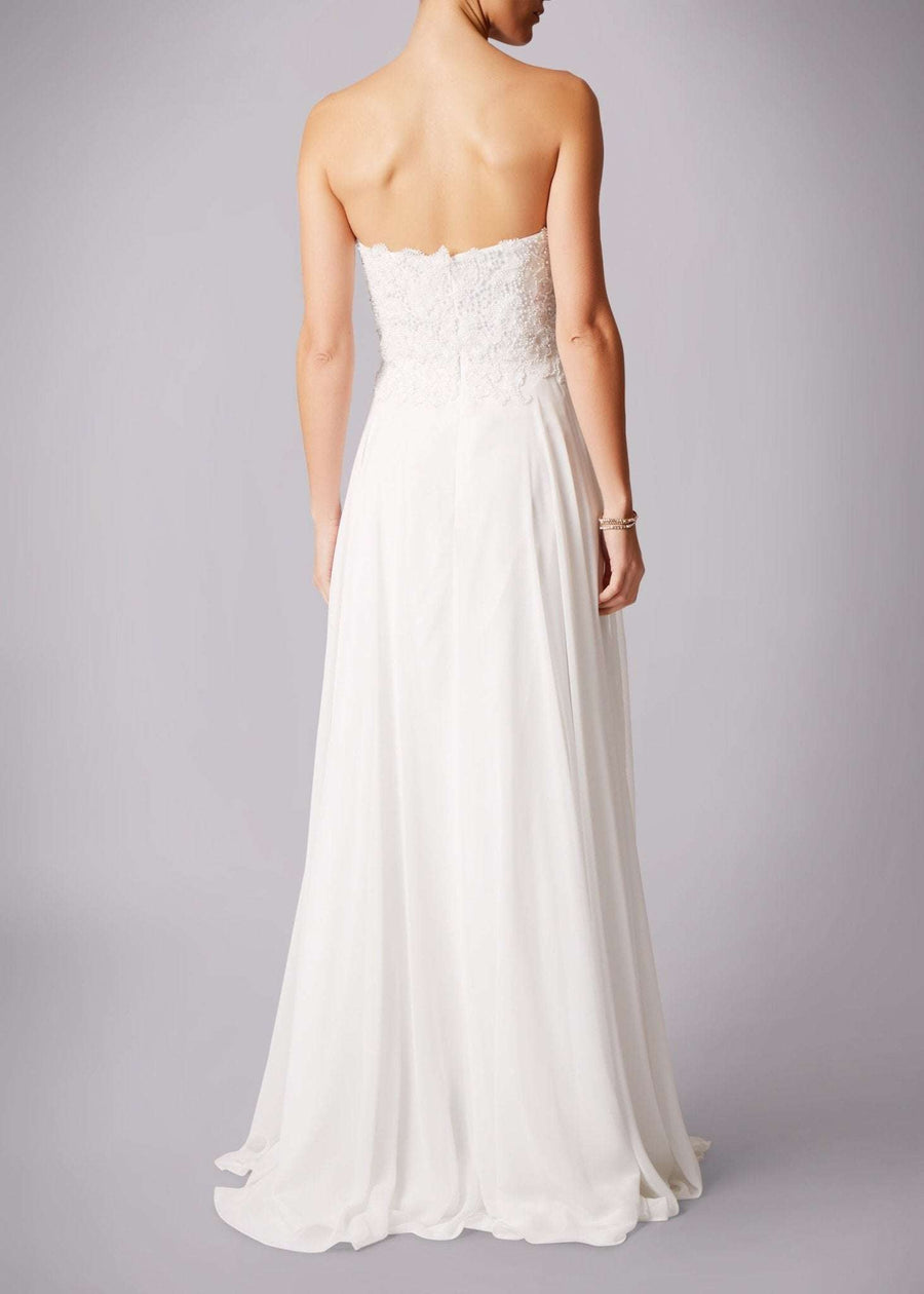 Back view of Mascara London Ivory sequined bustier wedding gown MC181283P featuring a strapless lace bodice and flowing chiffon skirt.