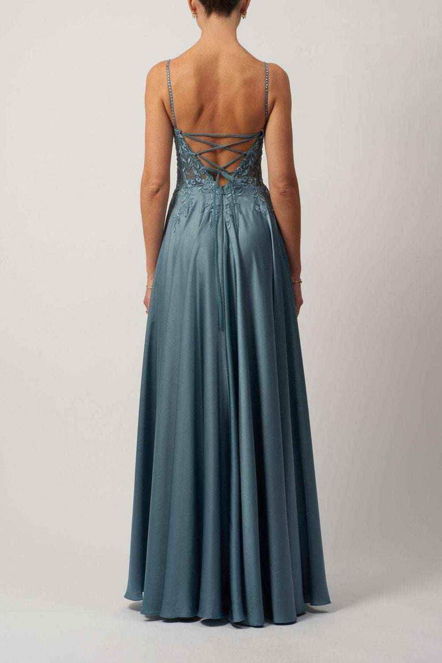 Back view of dusty blue satin corset dress with lace-up cross back and flowing skirt. Elegant choice for bridesmaids or special occasions.