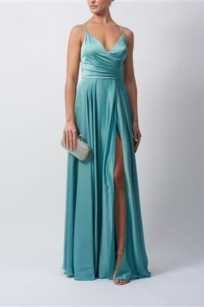 Young female standing in a misty green satin prom dress